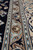 Detail of the tan guard stripe and bead chain running between navy field and ivory border