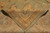 Corner folded back to reveal the reverse, even knot rows and pale ivory fringe