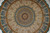 Close view of the centre rosette and radiating sunburst ringed by ivory arch panels