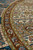 Raking view along the curved cinnamon border with olive guard stripes and pink rosettes