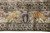 Border detail of two golden stags flanking an indigo tulip vase between floral meanders