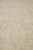 Raking macro of the pile, raised ivory motifs standing above the matte oatmeal ground