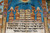 Centre panel with two stone tablets, kneeling winged figures, oil lamps and black lettering
