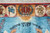 Top border detail with crown, tribal roundels and rayed sun over turquoise ground