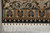 End border straight on with black cartouche panels, ivory rosette guard row and long fringe