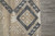 Corner detail where the charcoal panel meets the selvedge beside grey tile flooring