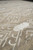 Low angle across the pile with ivory square motifs and wandering outlined shapes