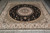 Overhead view of the rug on grey flooring, fringe visible along the near end