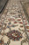 Ivory main border seen along its length, palmettes and bouquets between narrow guard stripes
