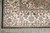 Corner detail with olive inner ground, mitred ivory border and combed ivory fringe