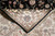 Corner turned back to show the finely knotted reverse, black selvage and ivory fringe