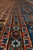 Camel brown guard stripes with pale blue rosettes beside the mid-blue main border