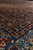 Low angle across a corner, medallion edge, dark navy band and blue border in sequence