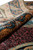 Rug rolled back at the border, showing pile depth and dark teal guard stripes