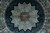 Close view of the twelve-point star medallion and plum knotwork centre on black ground