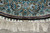 Border edge with ivory end band of small rosette squares and long white fringe