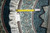 Tape measure and vendor tag reading 4' x 4' laid across the rug edge