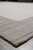 Low angle along one corner, grey border catching the light against the paler centre