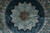 Close view of the pointed star medallion, pale blue panels and ochre vinework on ink black ground