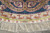 Edge detail with a small inscribed cartouche woven into the ivory flatweave between rose motifs