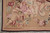 Corner of the rug with shell basket, pink peonies, red carnations and dark brown selvedge