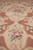 Close view down the centre line showing the medallion's lower half and small flower sprays
