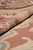 Rug folded back to show the reverse, flat tapestry weave with the design repeated behind