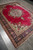 Angled floor view with the near corner and layered navy border in the foreground