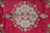 Close overhead of the central medallion, pale green ground with pink and cream floral tracery