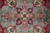 Macro of the medallion core showing pink star, navy leaves and small crimson rosettes