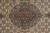 Close-up of the central medallion, grey-green ground with brown core and rose-pink outline