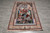 Angled floor view of the full rug on grey tile, arch and garden scene upright