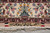 End border with irises and partridges above the signature cartouche and ivory fringe