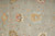 Field detail with a pale blue and gold rosette beside a coral and olive palmette