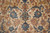 Close view of the field, vine scrolls with teal palmettes and rose flower heads on beige