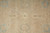 Close view of field motifs: cream oval rosettes, blue flowerheads and faint lattice