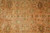 Close view of field motifs: brown palmettes, cross-shaped flower heads and small dotted leaves