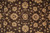 Close view of the field centre with ivory palmettes and scrolling vines on chocolate brown