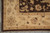 Corner detail of the sand border with rosettes, dark brown outer edge and pale fringe