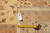 Reverse side with hand woven tag reading 12.2 x 18.3 beside a yellow tape measure