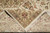 Folded back corner revealing even hand-knotted weave, cotton foundation and ivory warp fringe