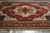 10 x 14 Indian Heriz Serapi rug angled on floor, ivory medallion and wide red border