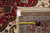 Tape measure and genuine hand woven oriental rug tag resting on the back of weave