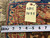 Yellow inventory tag marked 6815 with tape measure resting on the red brown woven back