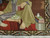 Corner detail with stacked books, striped red kilim and olive palmette border of Persian pictorial rug