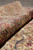 Rolled edge showing supple handle, soft wool pile and the multi-stripe border of this vintage rug