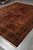 Full length view of this 9 by 12 Indian Oriental rug in burgundy, rust and green