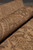 Rolled edge showing soft wool nap, tan border vines and subtle ivory guard stripes