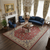Blue velvet sofa and armchairs arranged over the red and ivory hand-knotted Persian rug
