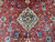 Ivory medallion framed by dense red field florals, blue palmettes and delicate vine work